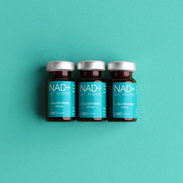 glutathione injection supplement vials laying flat birdseyeview on blue background
