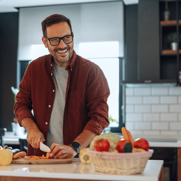 NAD and GLP-1. A middle aged man meal prepping vegetables.