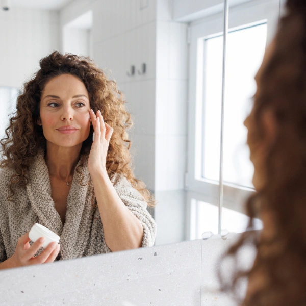 Does NAD+ Improve Skin Health? image of woman applying skin care